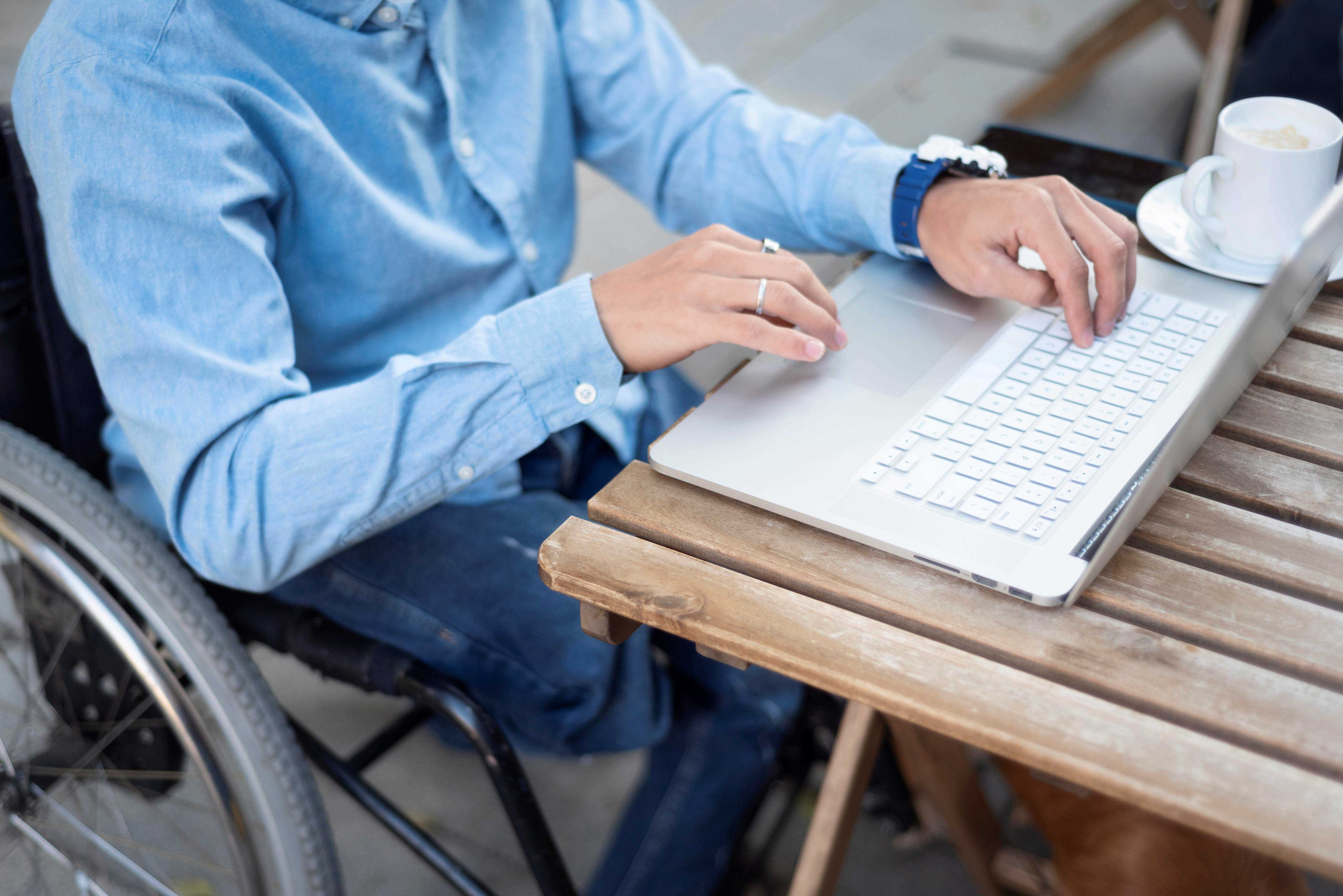 Disabled man working on laptop