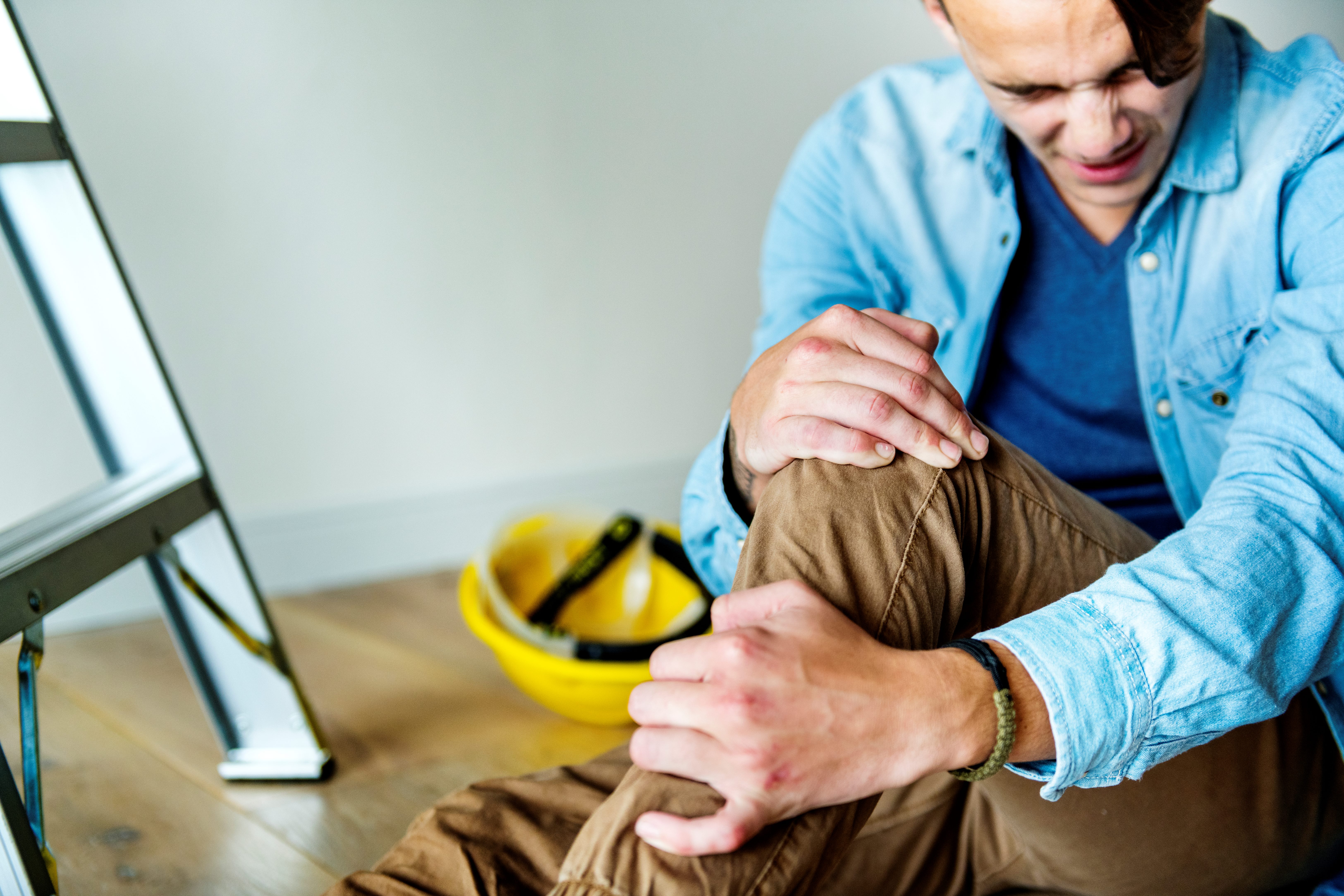 Man holding his knee in pain. Man holding his knee in pain.